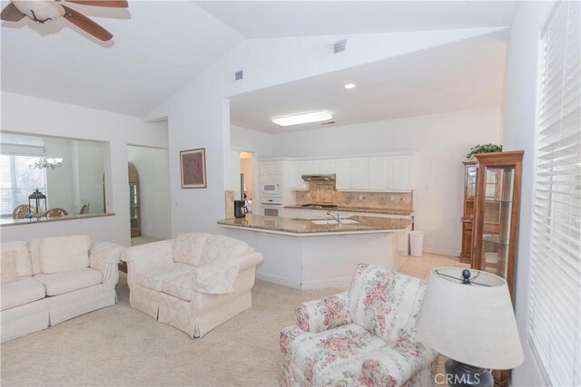 1490 N Dewitt Ave, Clovis, CA 93619 - living area with vaulted ceiling, ceiling fan with notable chandelier, arched walkways, and visible vents