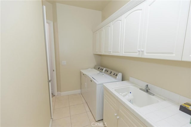 1490 N Dewitt Ave, Clovis, CA 93619 - laundry room featuring a sink, cabinet space, washing machine and clothes dryer, light tile patterned floors, and baseboards
