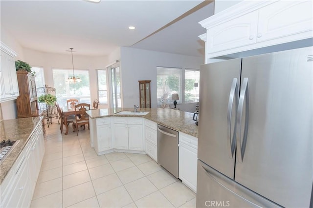 1490 N Dewitt Ave, Clovis, CA 93619 - kitchen featuring a chandelier, stainless steel appliances, light tile patterned flooring, and white cabinets