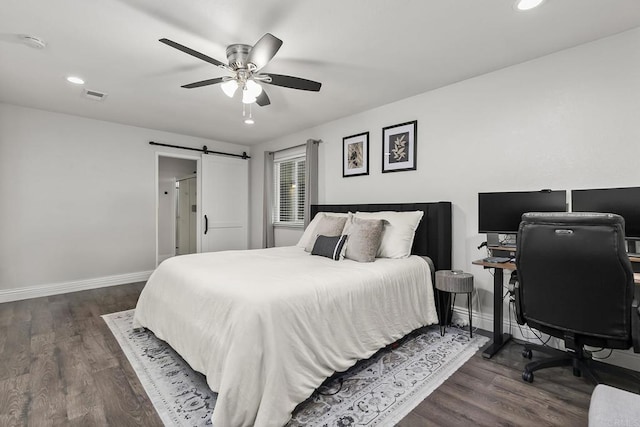 bedroom featuring a barn door, baseboards, visible vents, and recessed lighting