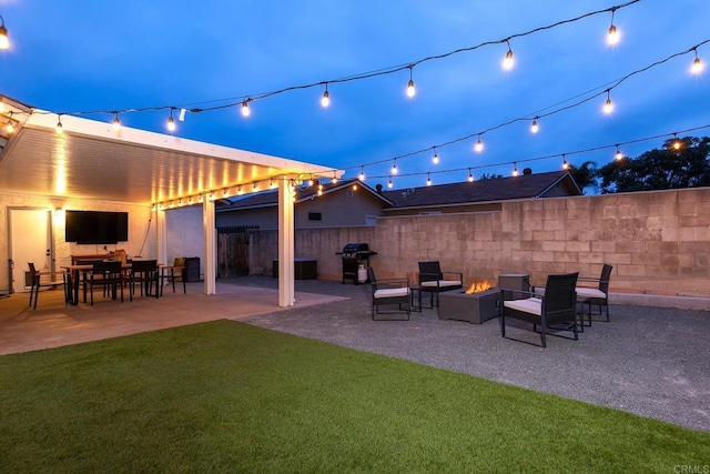 view of patio featuring an outdoor fire pit and fence