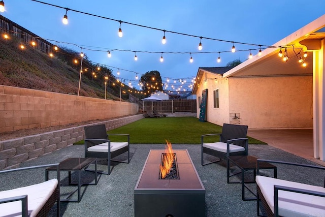 view of patio featuring an outdoor fire pit and a fenced backyard