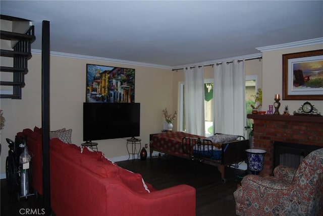 living room featuring crown molding, baseboards, wood finished floors, and a fireplace