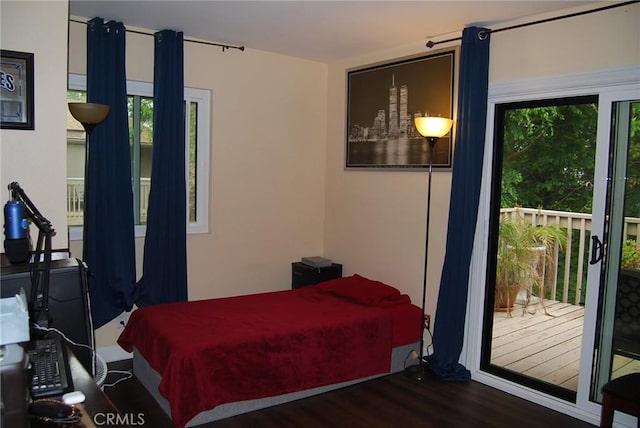 bedroom with wood finished floors and access to exterior