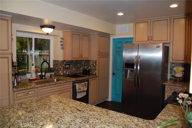kitchen with dishwasher, visible vents, a sink, stainless steel fridge with ice dispenser, and tasteful backsplash