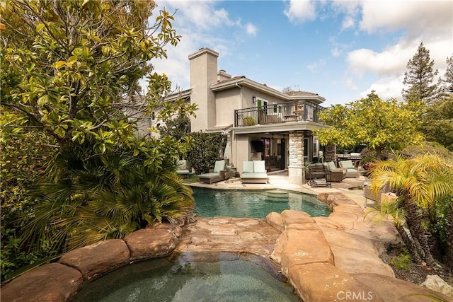 184 Halsbury Ct, Lake Sherwood, CA 91361 - rear view of property with a balcony, a chimney, a patio, an outdoor pool, and an in ground hot tub