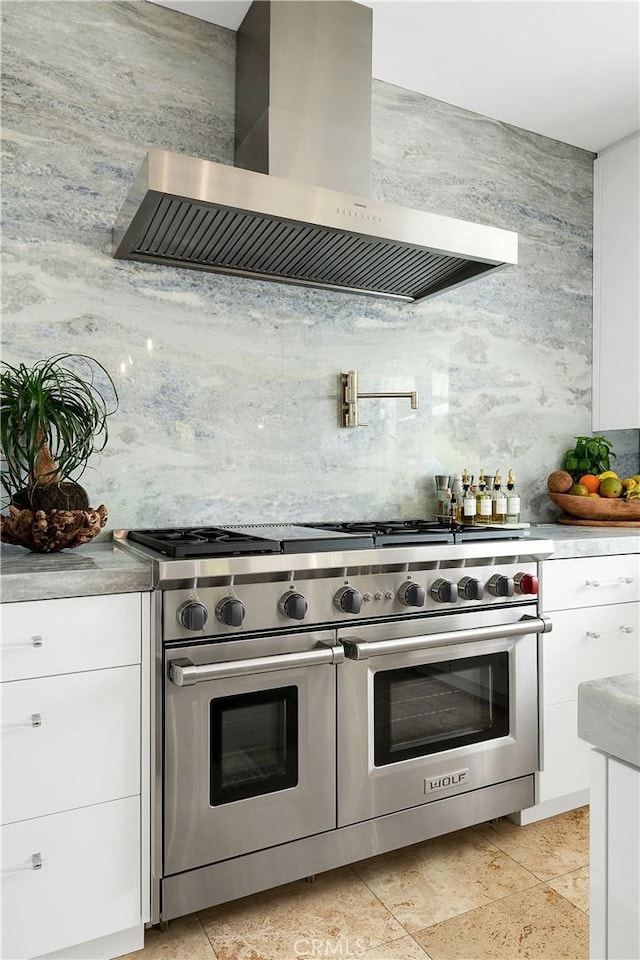 184 Halsbury Ct, Lake Sherwood, CA 91361 - kitchen featuring wall chimney range hood, backsplash, light countertops, white cabinets, and double oven range