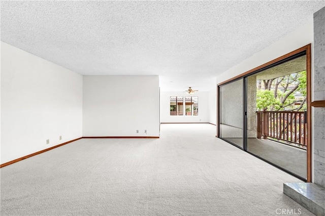 unfurnished living room with baseboards, carpet flooring, and a textured ceiling