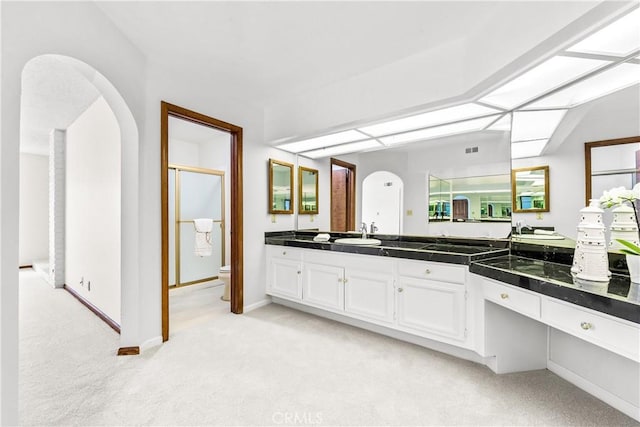 full bath featuring vanity, toilet, a shower stall, and carpet floors