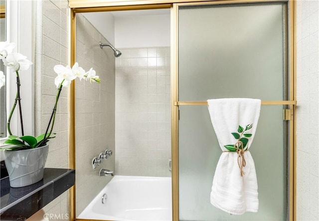bathroom with shower / bath combination with glass door