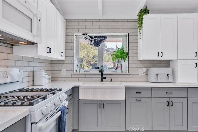 10541 Cliota St, Whittier, CA 90601 - kitchen with white appliances, gray cabinetry, backsplash, and light countertops