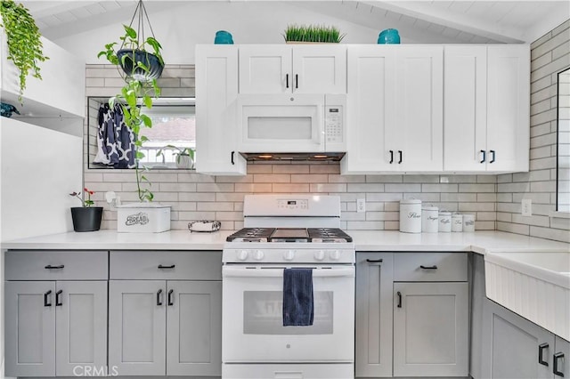 10541 Cliota St, Whittier, CA 90601 - kitchen with white appliances, gray cabinetry, decorative backsplash, and light countertops
