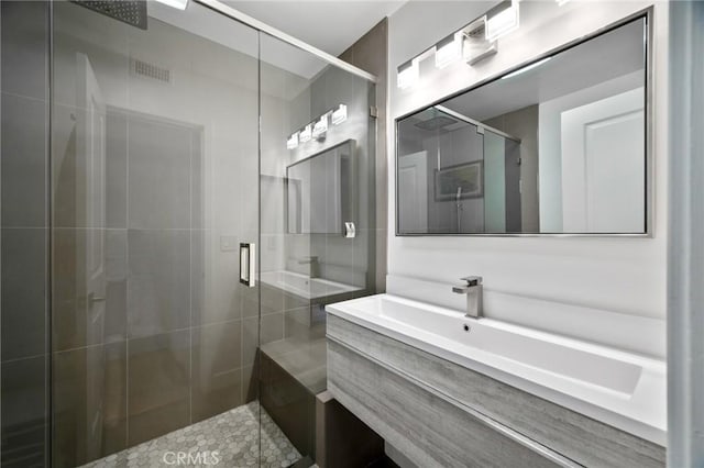 full bathroom featuring vanity, tile patterned flooring, and a shower stall