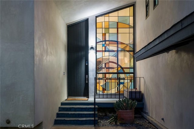 entrance to property featuring stucco siding