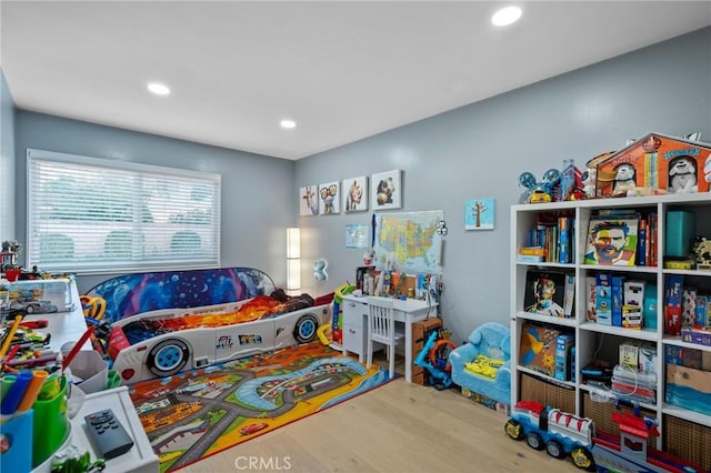 game room with recessed lighting and wood finished floors