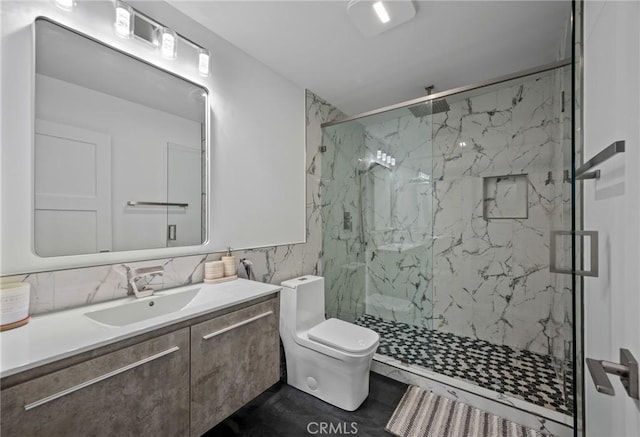 full bathroom with vanity, toilet, backsplash, and a marble finish shower