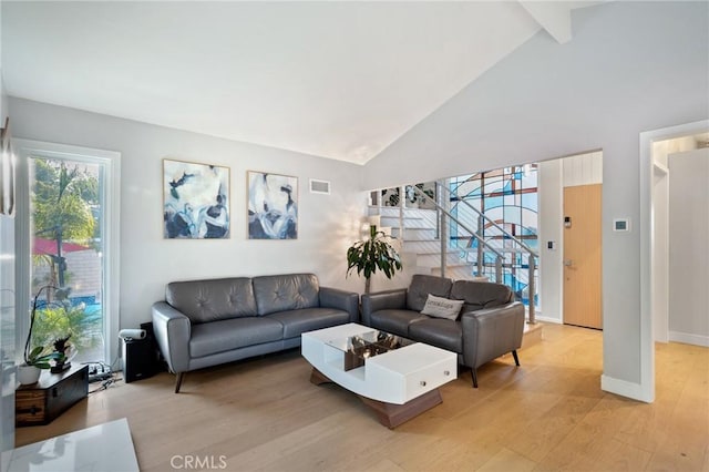 living room with high vaulted ceiling, light wood-type flooring, visible vents, beamed ceiling, and baseboards