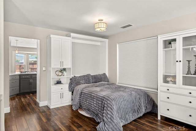 bedroom with baseboards, dark wood-style flooring, and visible vents
