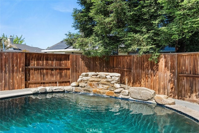 view of swimming pool featuring fence and a fenced in pool