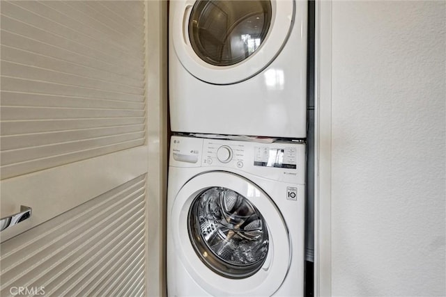washroom with laundry area and stacked washing maching and dryer