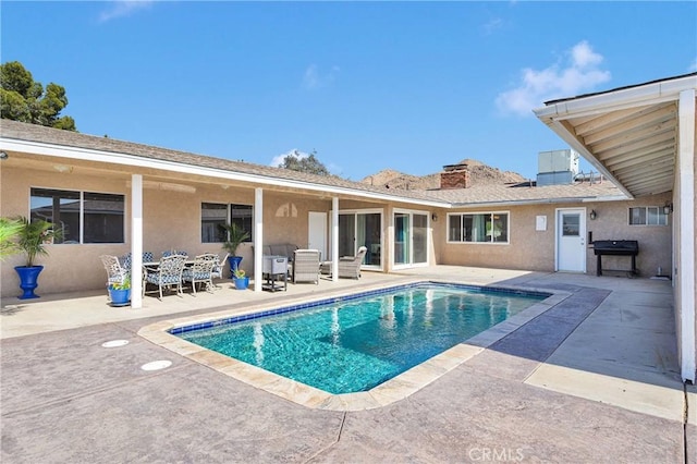 outdoor pool featuring a patio and outdoor dining space