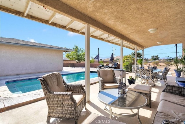 view of swimming pool with a patio area, a fenced in pool, and fence