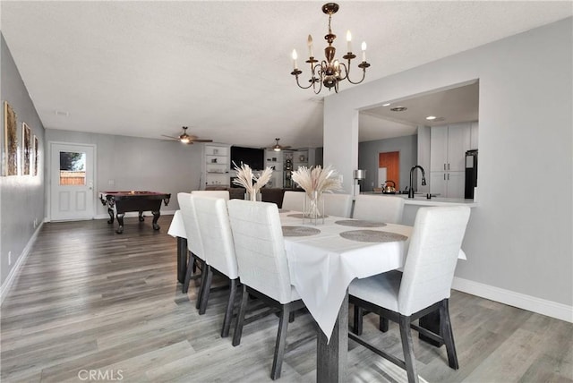 dining room featuring light wood-style floors, baseboards, ceiling fan with notable chandelier, and pool table