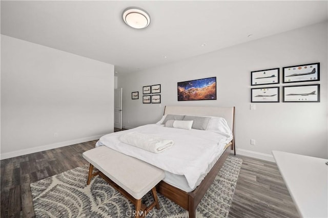 bedroom with baseboards and wood finished floors