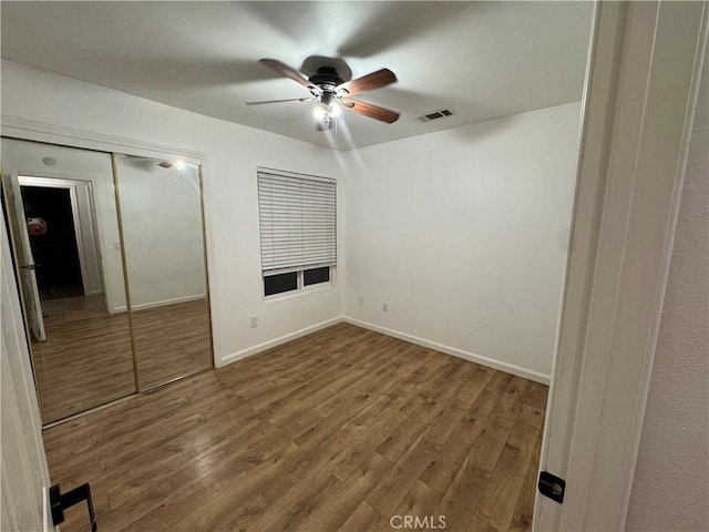 52415 Avenida Vallejo Ln, Quinta, CA 92253 - unfurnished bedroom with wood finished floors, a closet, baseboards, and a ceiling fan