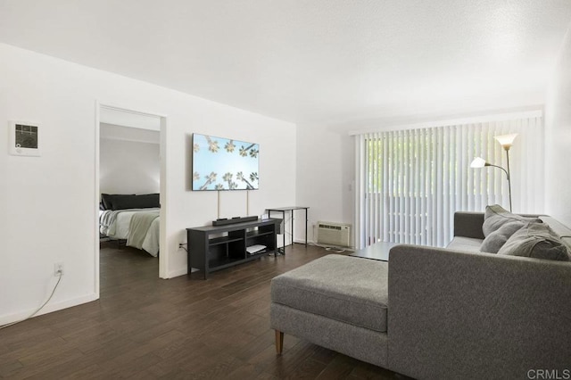 living area featuring baseboards, dark wood finished floors, visible vents, and an AC wall unit
