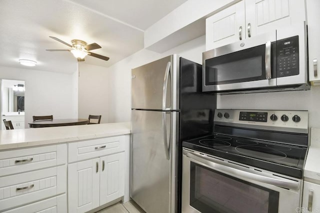 kitchen featuring appliances with stainless steel finishes, a ceiling fan, and white cabinetry