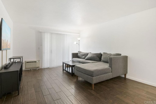 living room featuring baseboards, a wall mounted AC, and dark wood-style floors