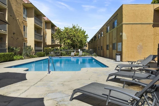 community pool with a patio area