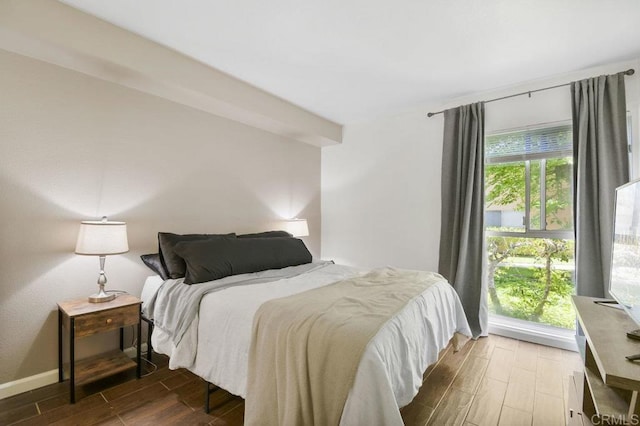 bedroom featuring baseboards and wood finished floors