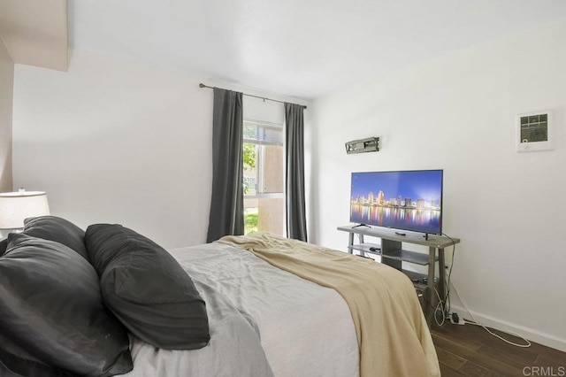 bedroom featuring baseboards and dark wood finished floors