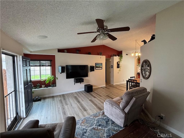 15957 Randall Ave Unit 34, Fontana, CA 92335 - living area featuring vaulted ceiling, a ceiling fan, wood finished floors, and a textured ceiling
