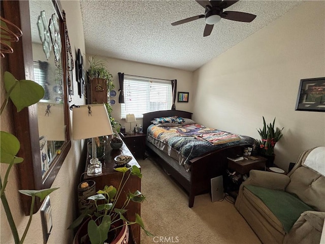bedroom featuring a ceiling fan, carpet, a textured ceiling, and lofted ceiling