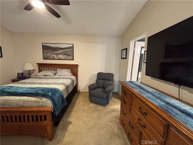 bedroom with vaulted ceiling, light carpet, and a ceiling fan