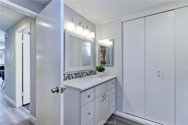 774 Via Los Altos Unit P, Laguna Woods, CA 92637 - bathroom with vanity, wood finished floors, and backsplash