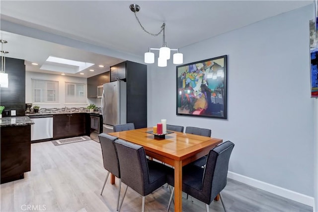 774 Via Los Altos Unit P, Laguna Woods, CA 92637 - dining room with light wood-style floors, baseboards, a skylight, and recessed lighting