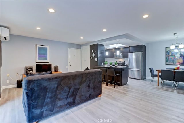 774 Via Los Altos Unit P, Laguna Woods, CA 92637 - living room with a wall unit AC, baseboards, light wood-style floors, and recessed lighting