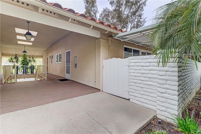 774 Via Los Altos Unit P, Laguna Woods, CA 92637 - view of side of home with stucco siding, covered porch, and a tiled roof