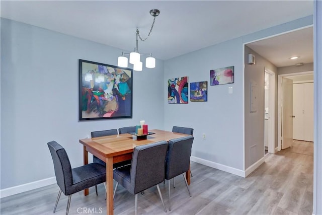 774 Via Los Altos Unit P, Laguna Woods, CA 92637 - dining room featuring a chandelier, baseboards, and light wood-style floors