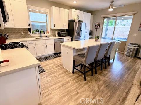kitchen featuring a sink, stainless steel appliances, and light wood-style floors