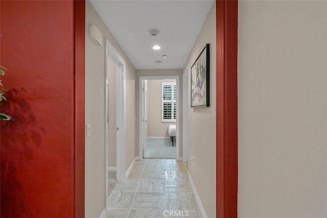 102 Rose Arch Unit 23, Irvine, CA 92620 - hallway with stone tile floors, baseboards, and recessed lighting