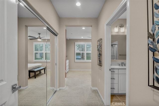 102 Rose Arch Unit 23, Irvine, CA 92620 - corridor featuring carpet floors, recessed lighting, baseboards, and a sink