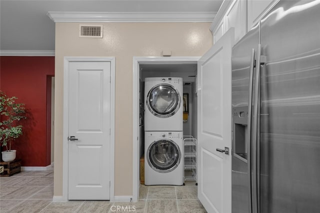 102 Rose Arch Unit 23, Irvine, CA 92620 - laundry room featuring stacked washer / drying machine, crown molding, and baseboards