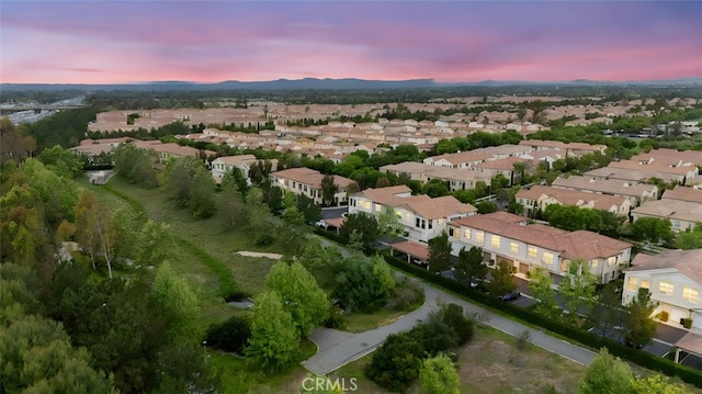 102 Rose Arch Unit 23, Irvine, CA 92620 - aerial view of property's location with nearby suburban area and a mountain backdrop