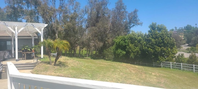 view of yard featuring fence and a pergola