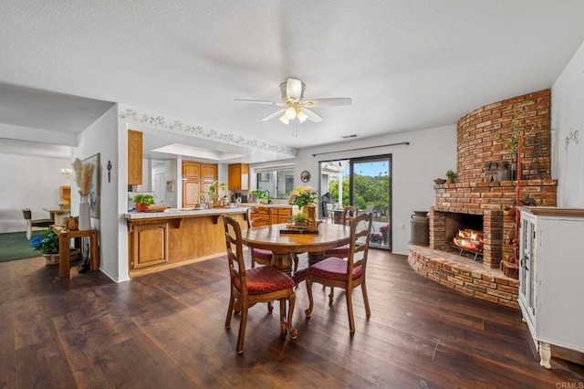 3048 Jason Rd, Fallbrook, CA 92028 - dining room with dark wood finished floors, ceiling fan, a fireplace, and a textured ceiling